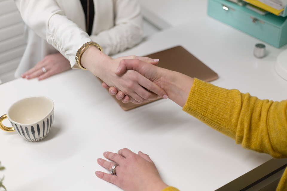 Two people shaking hands after a successful hire